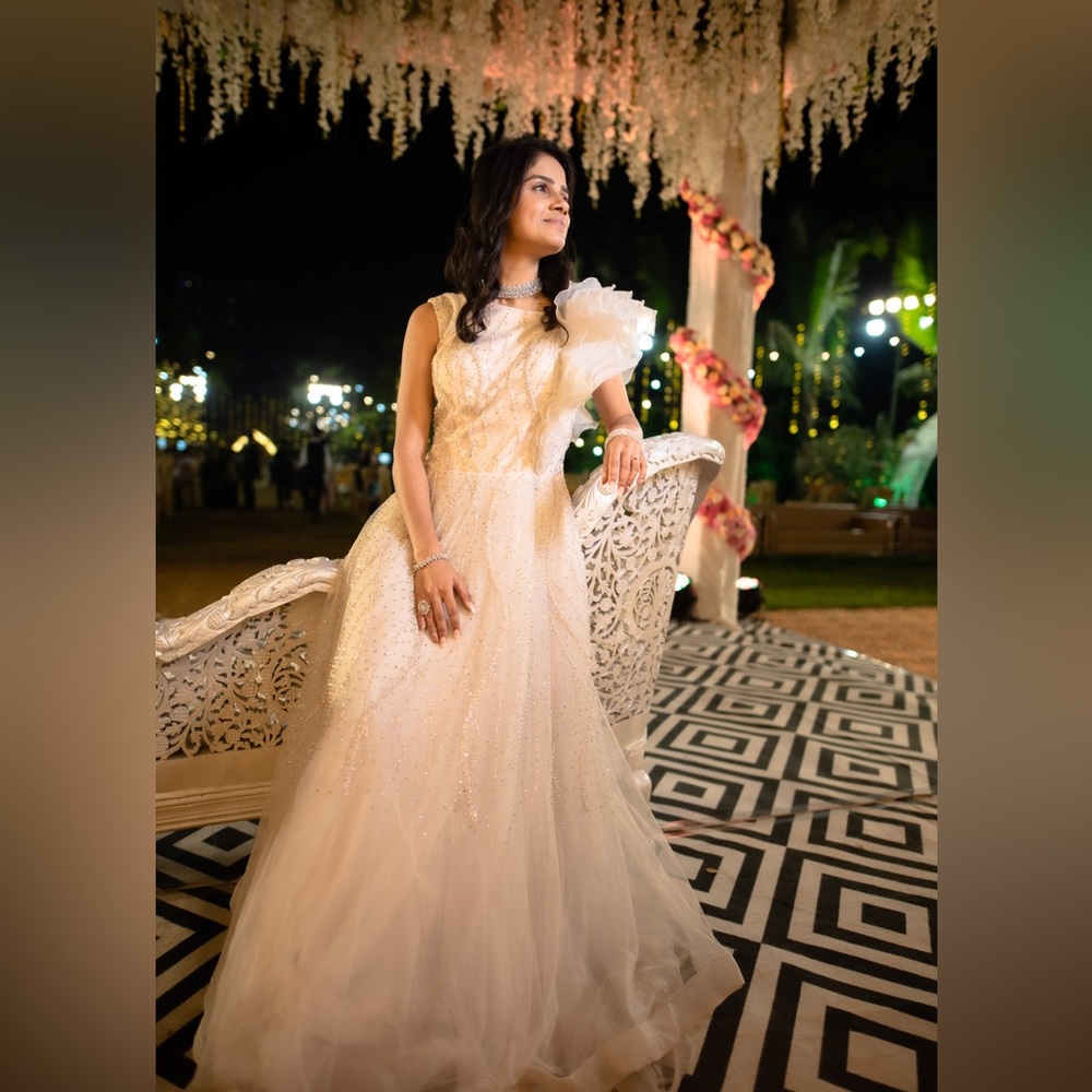 Beautifully designed peachy white evening gown.